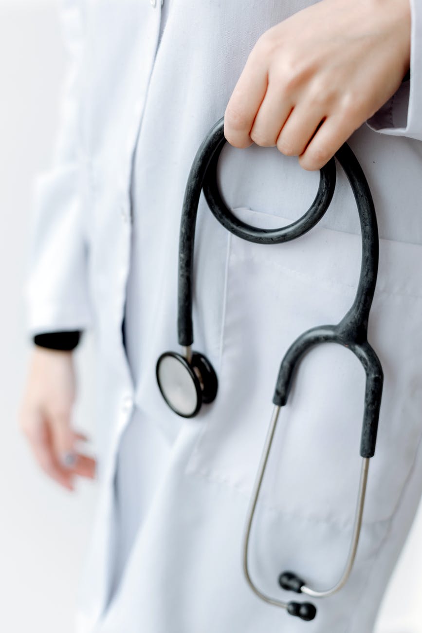 black and silver stethoscope on white textile